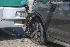 Car hitting bus bumper