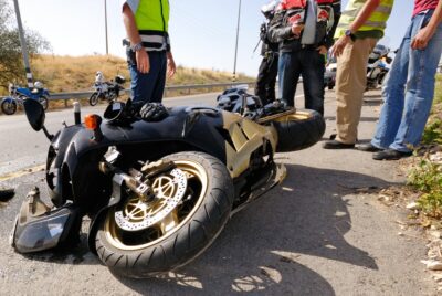 Men standing around a crashed motorcycle