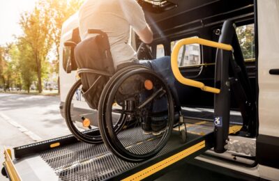 Man in a wheelchair on a bus lift