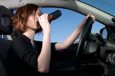 Woman drinking while driving