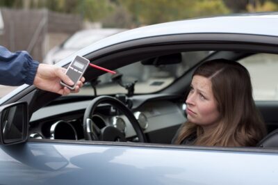 Woman taking a breathalyzer test