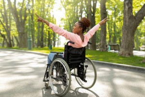 Happy black woman in a wheelchair