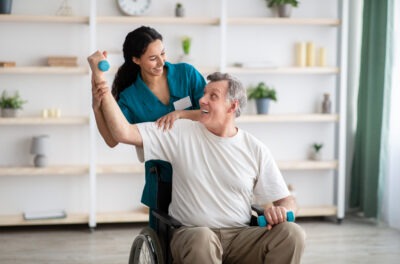 Man doing physical therapy in a wheelchair scaled