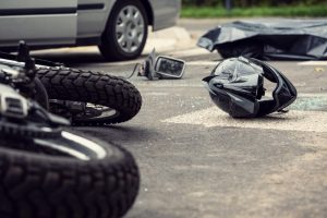 Motorcycle and silver car accident