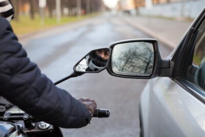 Motorcycle riding alongside car