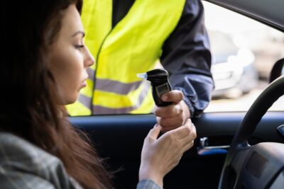 Woman taking a breathalyzer test 1