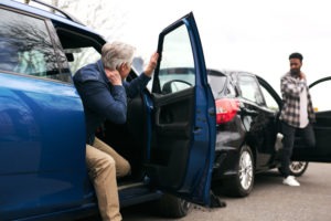 Older man injured after rear end collision getting out to confront driver