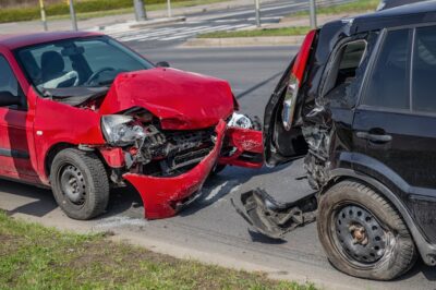 Red car and black suv in a rear end crash