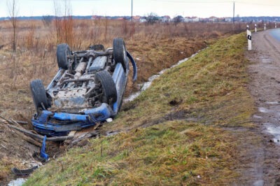 Blue car rolled over into a ditch scaled