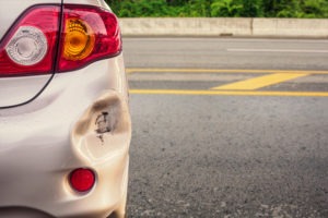 Gold car with damage after a hit and run scaled