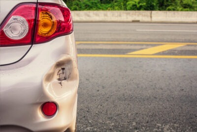 Gold car with damage after a hit and run scaled