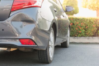 Gray car with hit and run damage