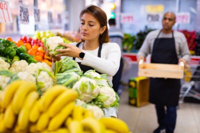 Young woman working in a grocery store scaled