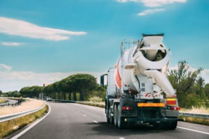 Cement truck driving down the road