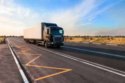 Delivery truck driving down the road scaled