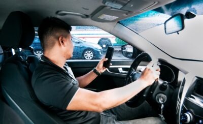 Man looking at cell phone and not the road scaled