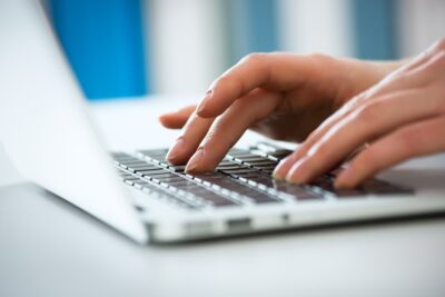 Woman typing a demand letter