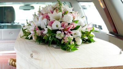 Casket in hearse with flowers