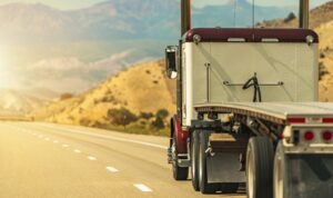 Flatbed truck driving down the road 1