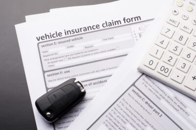 Insurance claim form with car keys