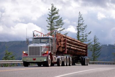 Logging truck driving down the road