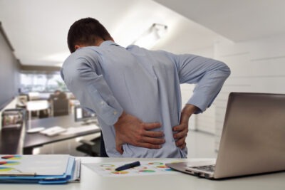 Man with back pain in the office