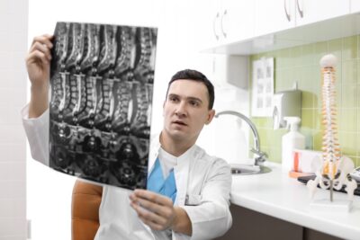 Physician reviewing an mri of vertebrae