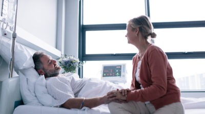 Woman visiting husband in the hospital scaled