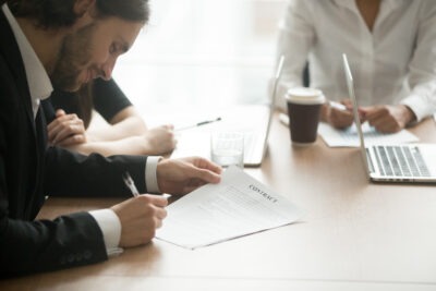 Lawyer taking notes during a deposition scaled