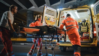 Paramedics loading patient into ambulance scaled