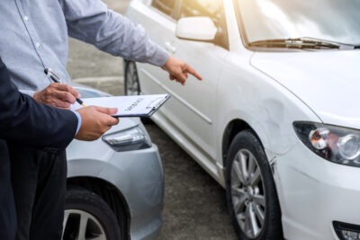 Insurance agent examine damaged car scaled