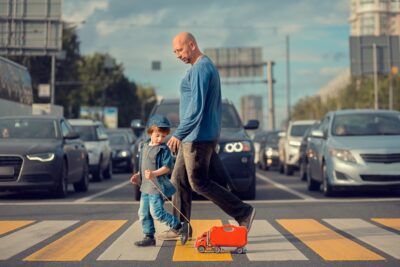 Man walking son through intersection