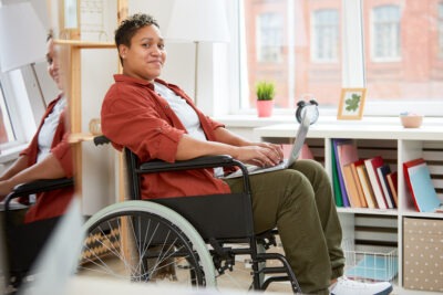 Black woman in wheelchair with disabilities scaled