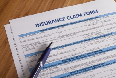 Insurance claim form with pen