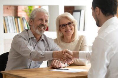 Clients smiling with attorney