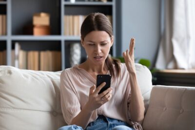 Confused angry woman on phone with insurance company