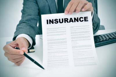 Man offering insurance policy to sign