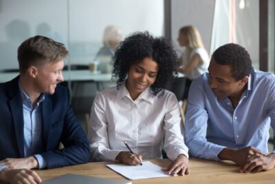 A woman signing an insurance settlement