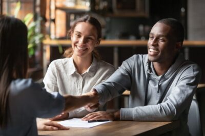 People shaking hands with an insurance agent