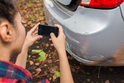 Georgia motorist taking pictures of car after an auto accident