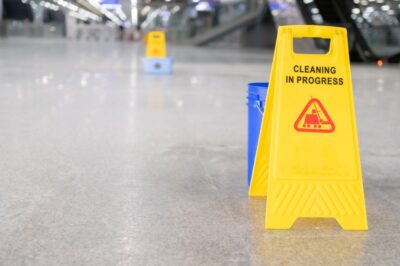 Cleaning in progress signs on floor