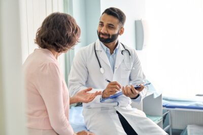 Indian doctor working with female patient