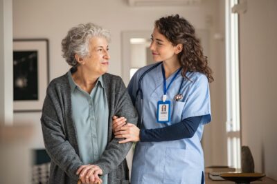 Nurse helping an older woman seek care