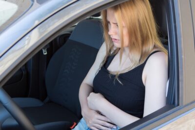 Woman feeling nauseated after a car crash