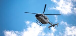 A helicopter flying low in the sky. Learn who investigates helicopter crashes.