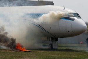 A plane is smoking after a crash, and the passengers are wondering how compensation for airplane crashes is calculated.