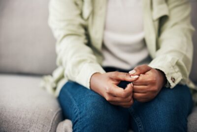 A woman sits with her hands folded in her lap as she learns how to report therapist sexual abuse in Georgia.