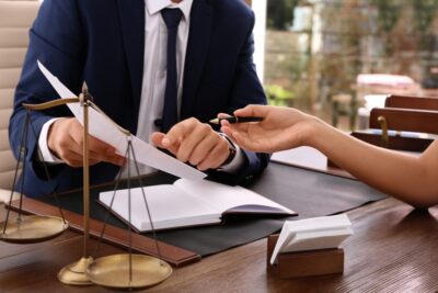 A lawyer talks with a client about whether the victim’s identity will be protected in a sexual abuse lawsuit. 