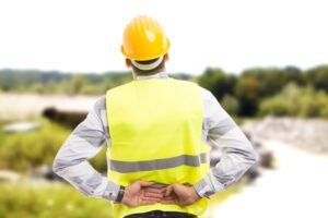 Worker with back injury. Does workers’ comp cover preexisting conditions? Learn how a lawyer can help you get the benefits you need.