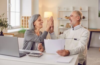 An elderly couple celebrating because they learned that much of their car accident settlement isn’t taxable in Georgia.